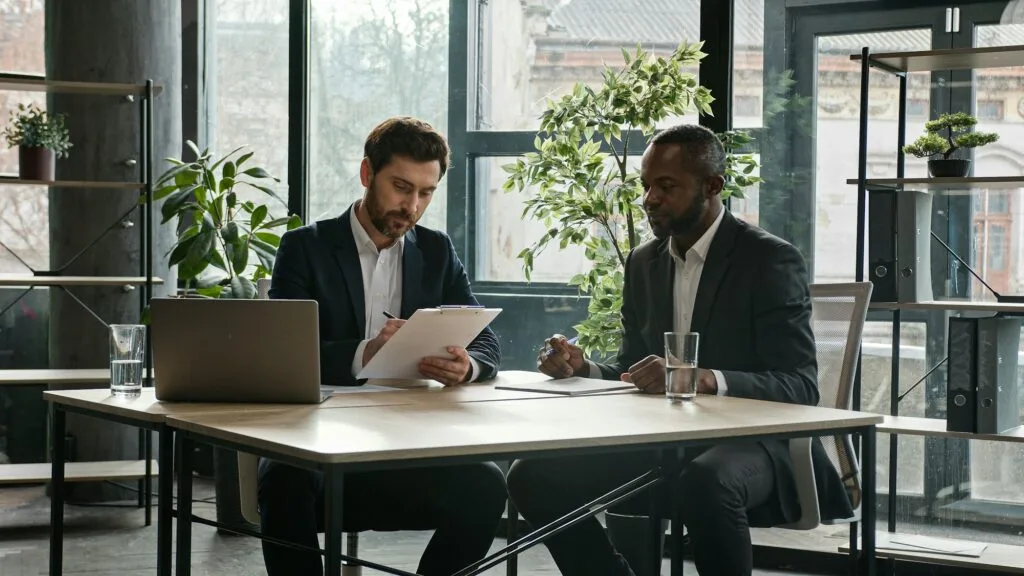 Moving camera diverse partners in office sign contract handshake cooperation Multiethnic Caucasian